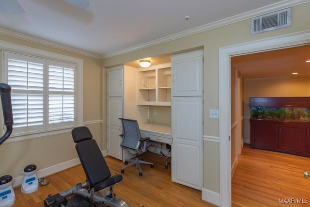 office space with ornamental molding, light wood finished floors, visible vents, and baseboards