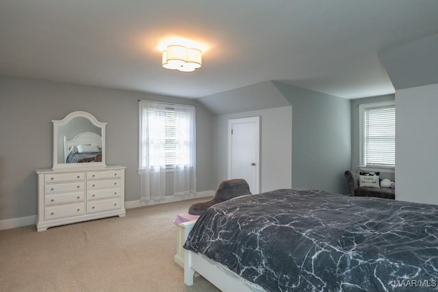 bedroom with light carpet, baseboards, and vaulted ceiling