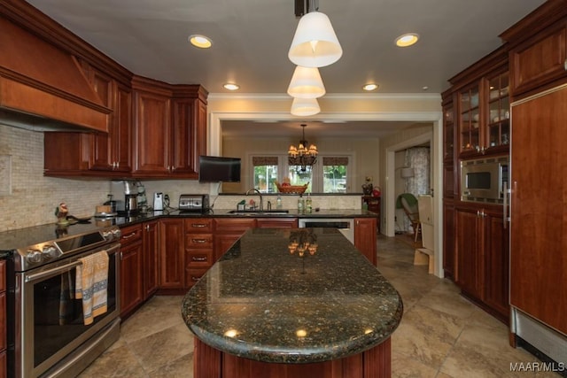 kitchen with a center island, tasteful backsplash, a sink, built in appliances, and premium range hood