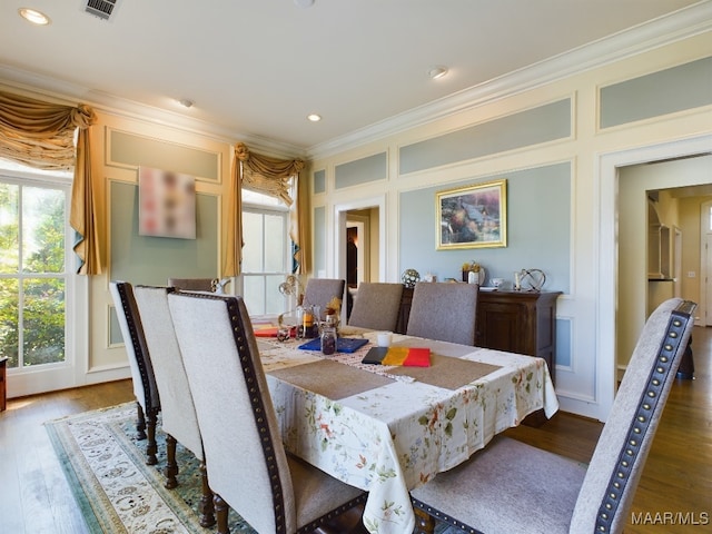 dining area with dark hardwood / wood-style floors and ornamental molding