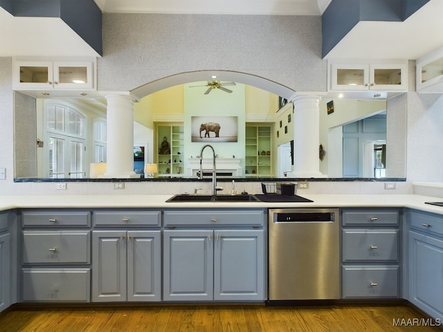 kitchen featuring light wood-type flooring, dishwasher, sink, ceiling fan, and ornate columns