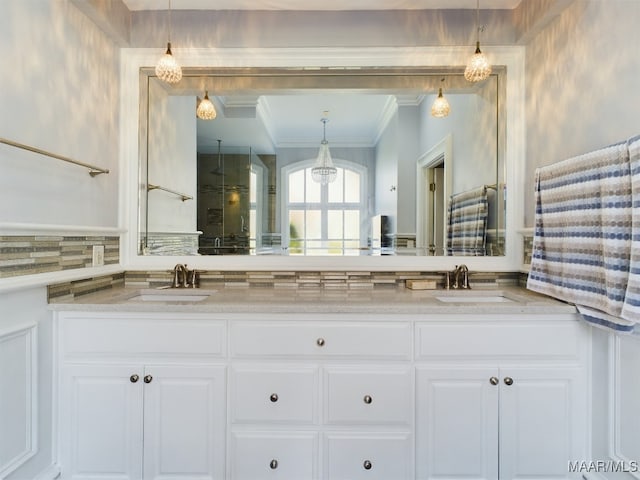 bathroom featuring ornamental molding, vanity, and tasteful backsplash