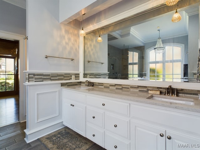 bathroom featuring tasteful backsplash, vanity, walk in shower, an inviting chandelier, and hardwood / wood-style floors