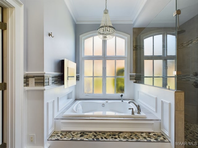 bathroom with a notable chandelier, a wealth of natural light, and independent shower and bath