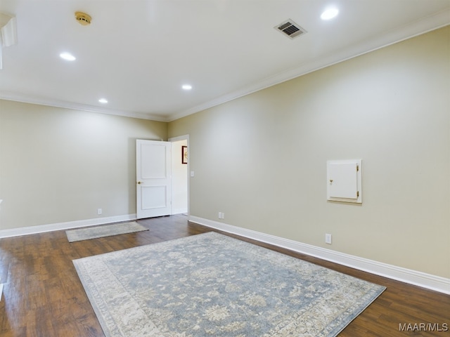 unfurnished room featuring crown molding and dark hardwood / wood-style flooring