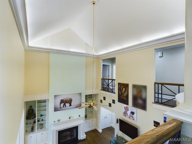 living room featuring vaulted ceiling, dark wood-type flooring, and ceiling fan