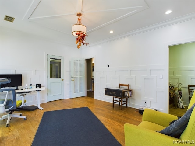 interior space with hardwood / wood-style flooring and crown molding