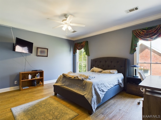 bedroom featuring crown molding, ceiling fan, and light hardwood / wood-style flooring