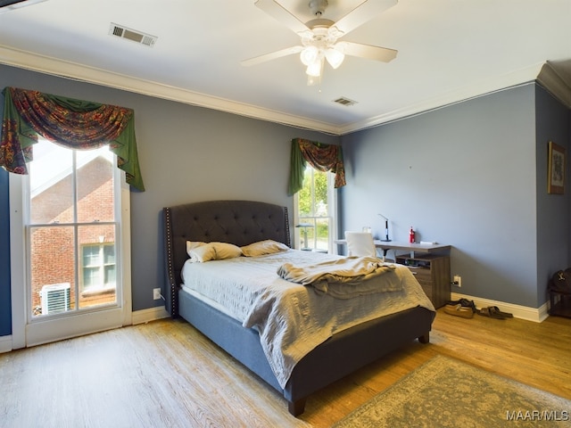 bedroom with ceiling fan, crown molding, and light hardwood / wood-style floors