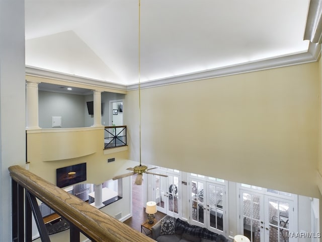 corridor with high vaulted ceiling and decorative columns