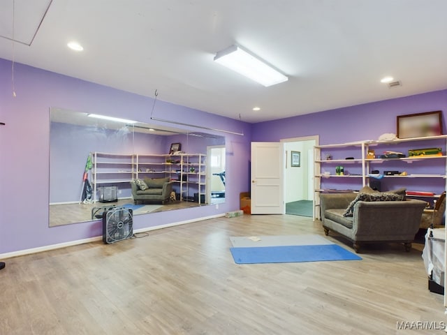 workout room with light hardwood / wood-style floors