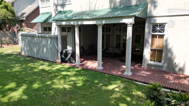 view of yard with ceiling fan and a patio area