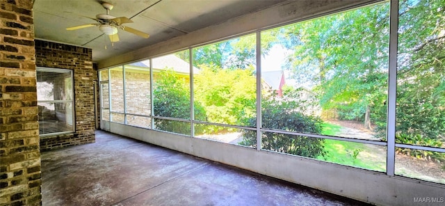 unfurnished sunroom with ceiling fan