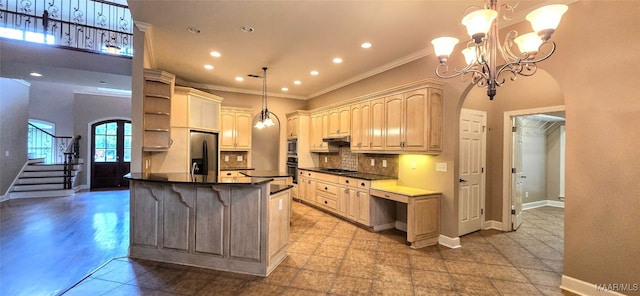 kitchen featuring hanging light fixtures, a notable chandelier, tasteful backsplash, light tile patterned floors, and stainless steel appliances