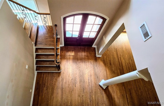 entryway featuring hardwood / wood-style flooring, a high ceiling, and french doors