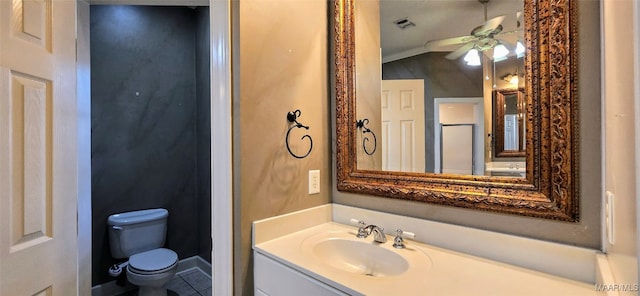 bathroom featuring toilet, vanity, crown molding, tile patterned floors, and ceiling fan