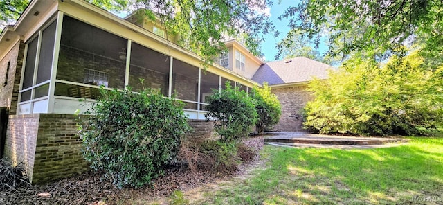 view of property exterior with a lawn and a sunroom