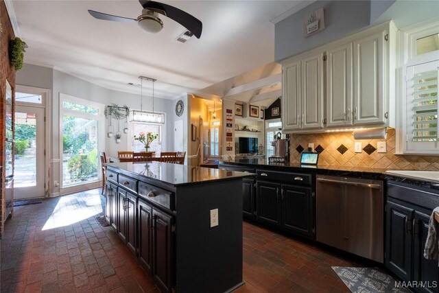 kitchen featuring decorative light fixtures, decorative backsplash, stainless steel dishwasher, a kitchen island, and ceiling fan