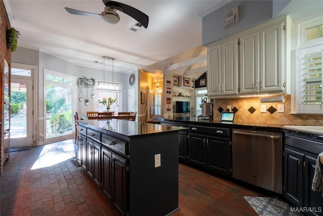 kitchen with decorative backsplash, dishwasher, dark countertops, brick floor, and dark cabinetry