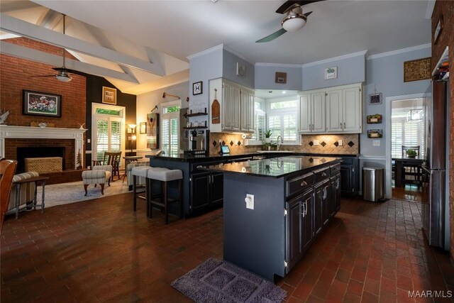 kitchen featuring ceiling fan, white cabinetry, and backsplash