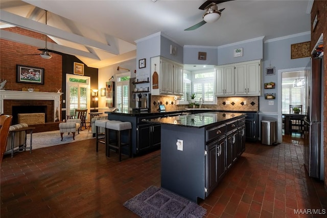 kitchen with white cabinets, dark countertops, ceiling fan, dark cabinetry, and backsplash