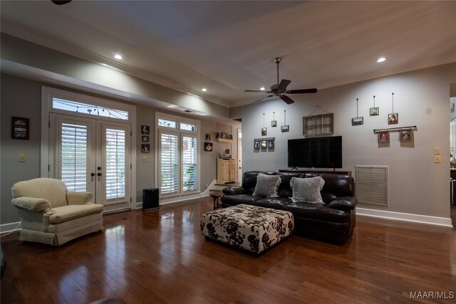 living room with ceiling fan, french doors, dark wood-type flooring, and ornamental molding