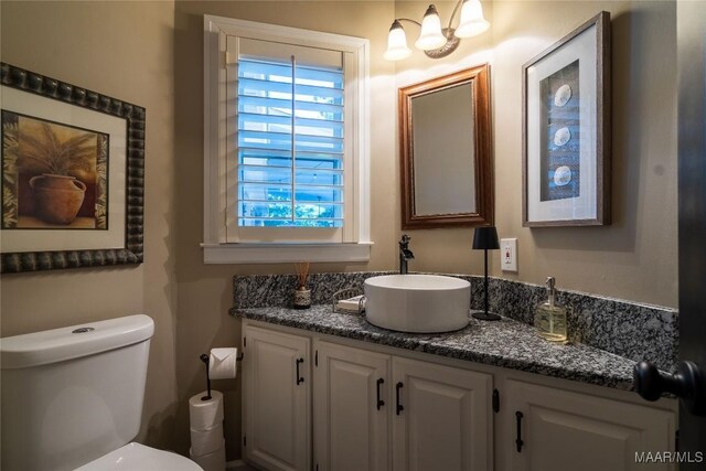 bathroom with toilet and vanity