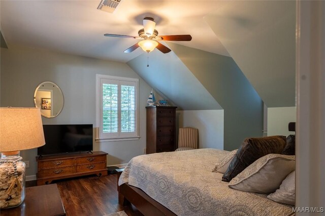 bedroom with ceiling fan, dark wood-type flooring, and lofted ceiling