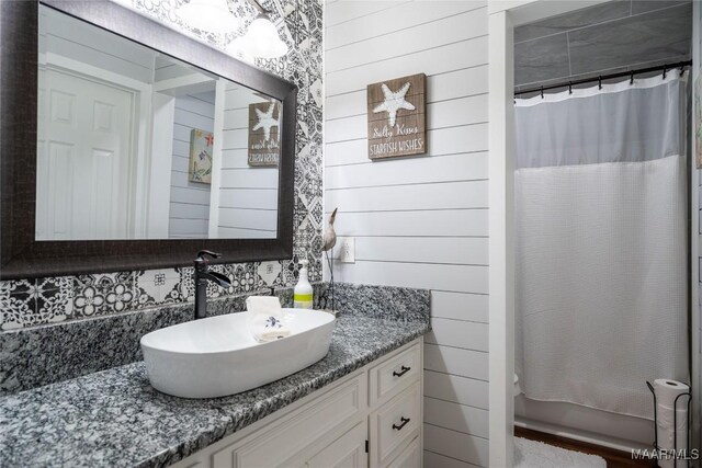 bathroom with shower / bath combo with shower curtain and vanity