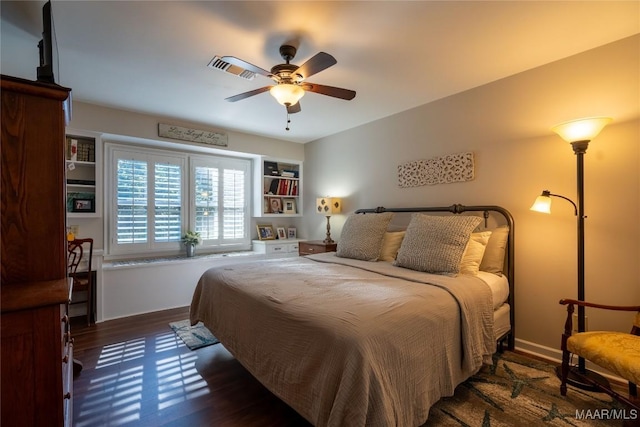 bedroom with a ceiling fan, baseboards, and wood finished floors