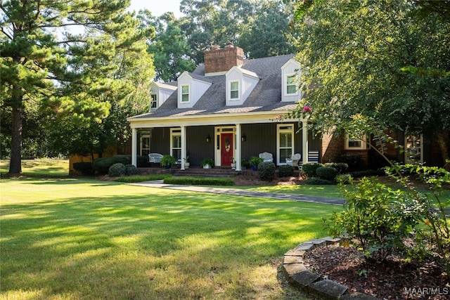 cape cod-style house with a front yard and covered porch