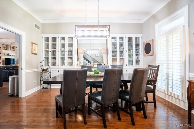 dining space featuring a healthy amount of sunlight, dark wood-style floors, stairs, and visible vents