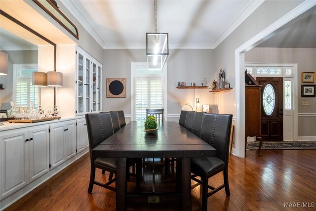 dining space featuring dark hardwood / wood-style floors and ornamental molding