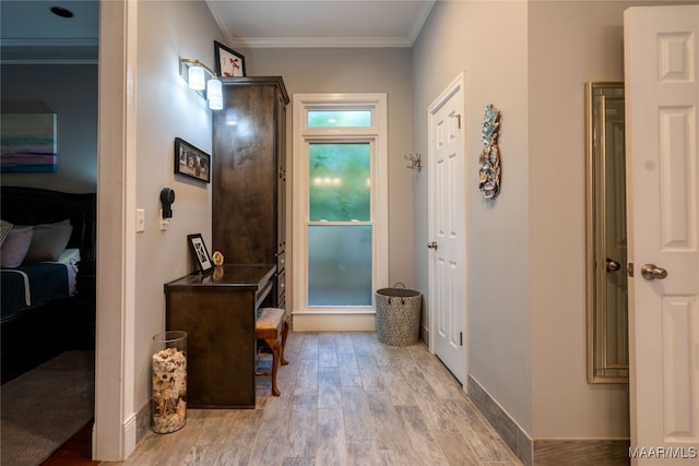 interior space with light hardwood / wood-style flooring and ornamental molding