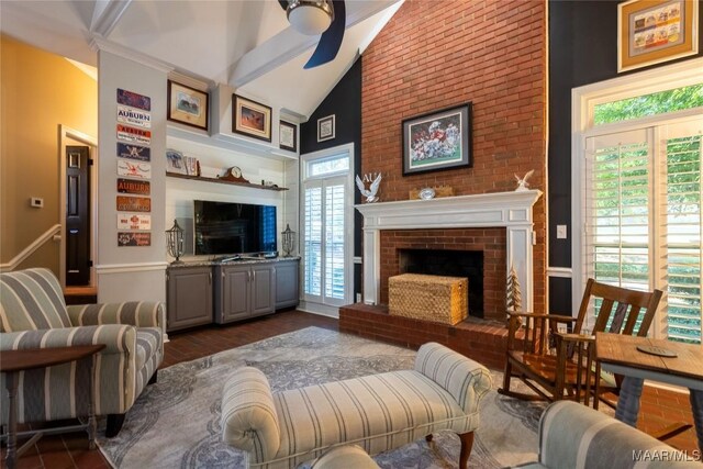 living room with a wealth of natural light, beamed ceiling, dark hardwood / wood-style floors, and a fireplace