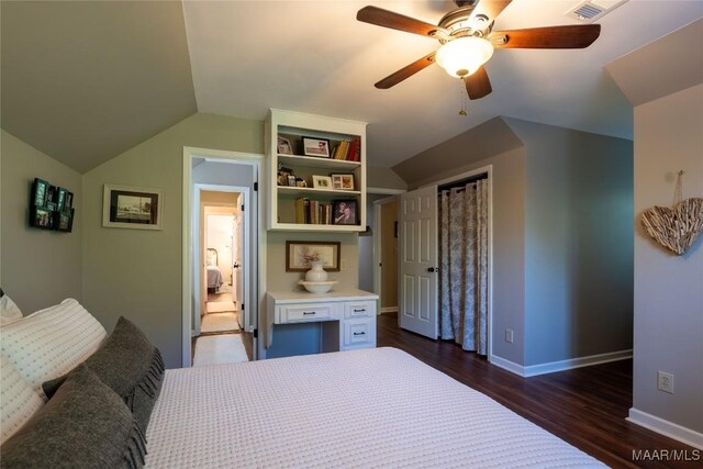 bedroom with dark hardwood / wood-style flooring, vaulted ceiling, and ceiling fan