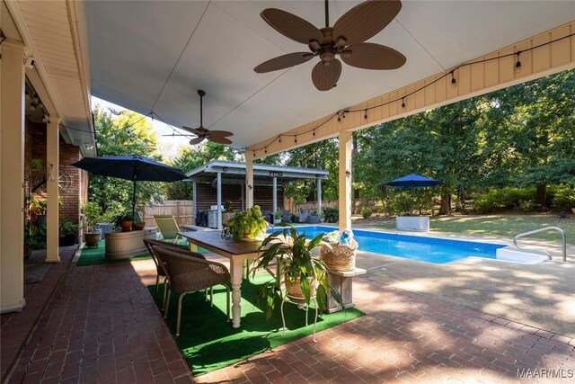 view of pool with ceiling fan and a patio