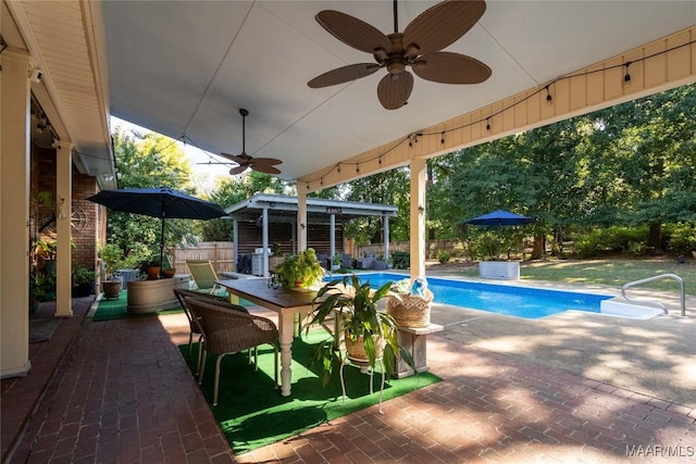 view of swimming pool with ceiling fan, a fenced in pool, fence, and a patio