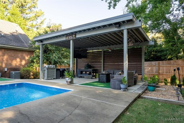 view of pool featuring an outdoor living space, a patio, a gazebo, and central AC unit