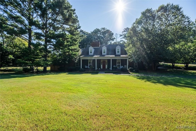 cape cod house with a porch and a front lawn