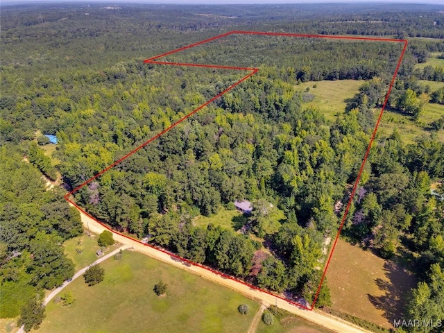 bird's eye view featuring a wooded view
