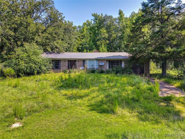 ranch-style home featuring metal roof