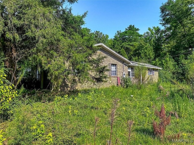 view of property exterior with brick siding