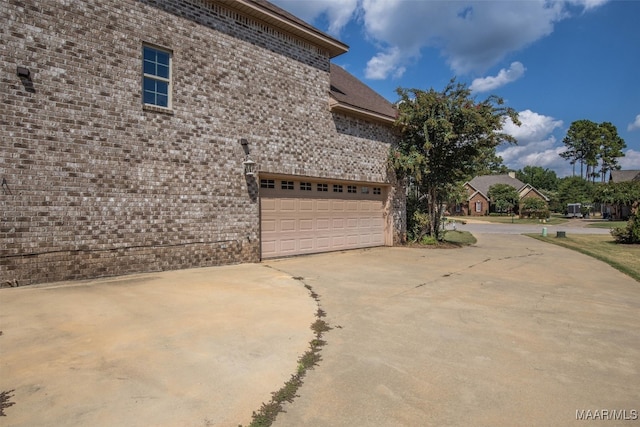 view of side of home with a garage