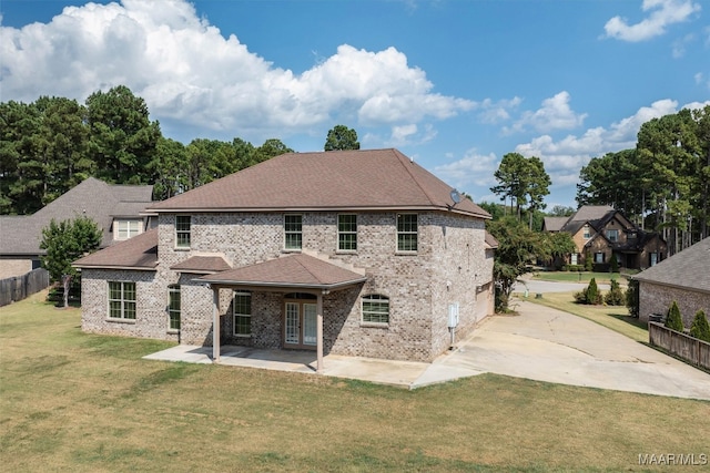 back of house featuring a patio and a lawn