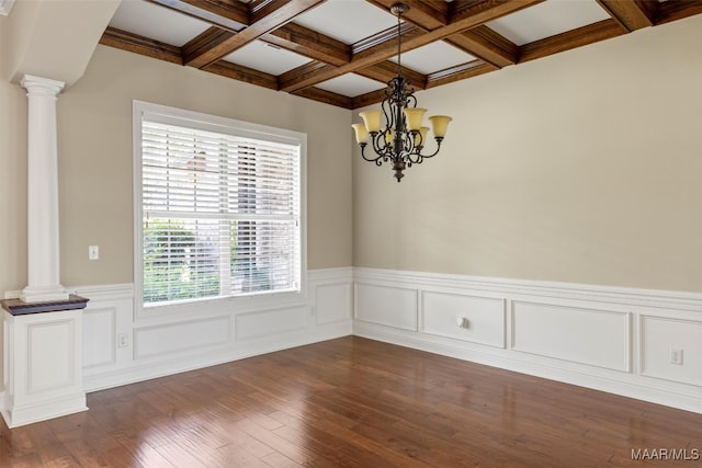 spare room featuring an inviting chandelier, coffered ceiling, decorative columns, beamed ceiling, and dark hardwood / wood-style flooring