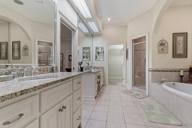 full bathroom featuring a sink, ornamental molding, a shower stall, a bath, and tile patterned floors