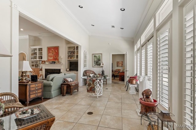 living area with built in shelves, light tile patterned flooring, recessed lighting, a fireplace, and ornamental molding