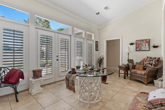 interior space featuring visible vents, crown molding, baseboards, and light tile patterned floors