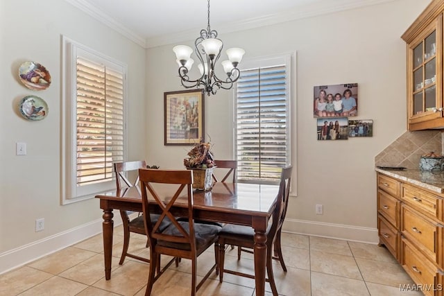 dining room with baseboards, light tile patterned flooring, and crown molding